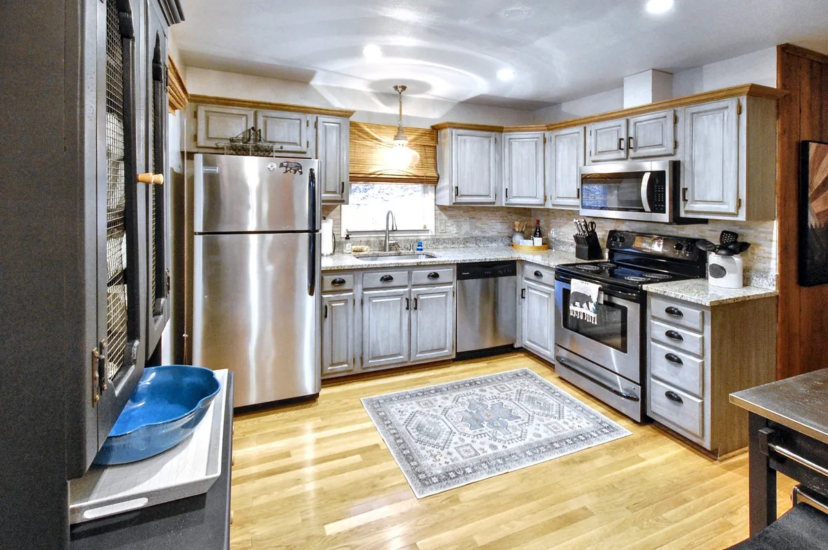 A modern, chef-ready kitchen with stainless steel appliances, granite countertops, a spacious kitchen island, and ample room for meal preparation. The space is open and welcoming, ideal for both culinary adventures and socializing.